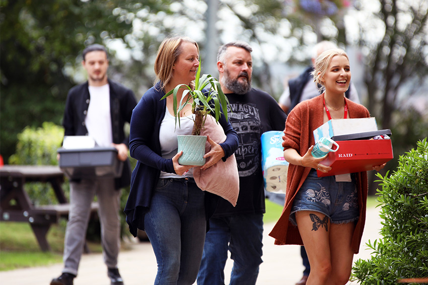 Parents help a student move into her halls on campus
