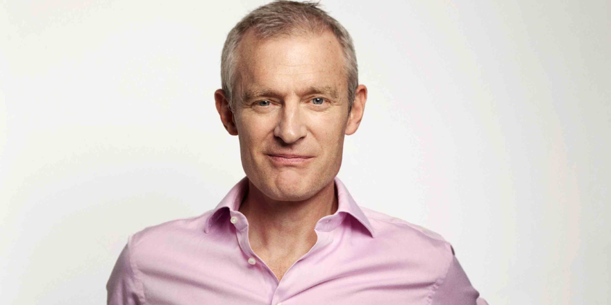 Man in pink shirt smiling