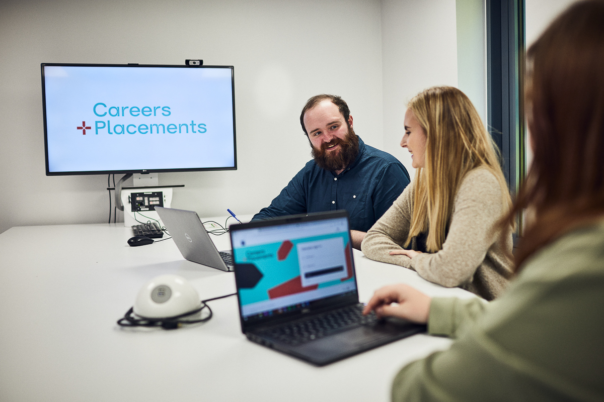 Students speaking with staff from the Careers and Placements team