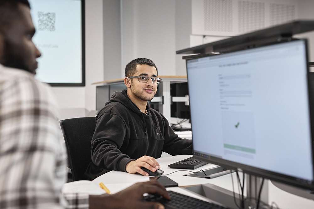 Computer Science student working at a computer