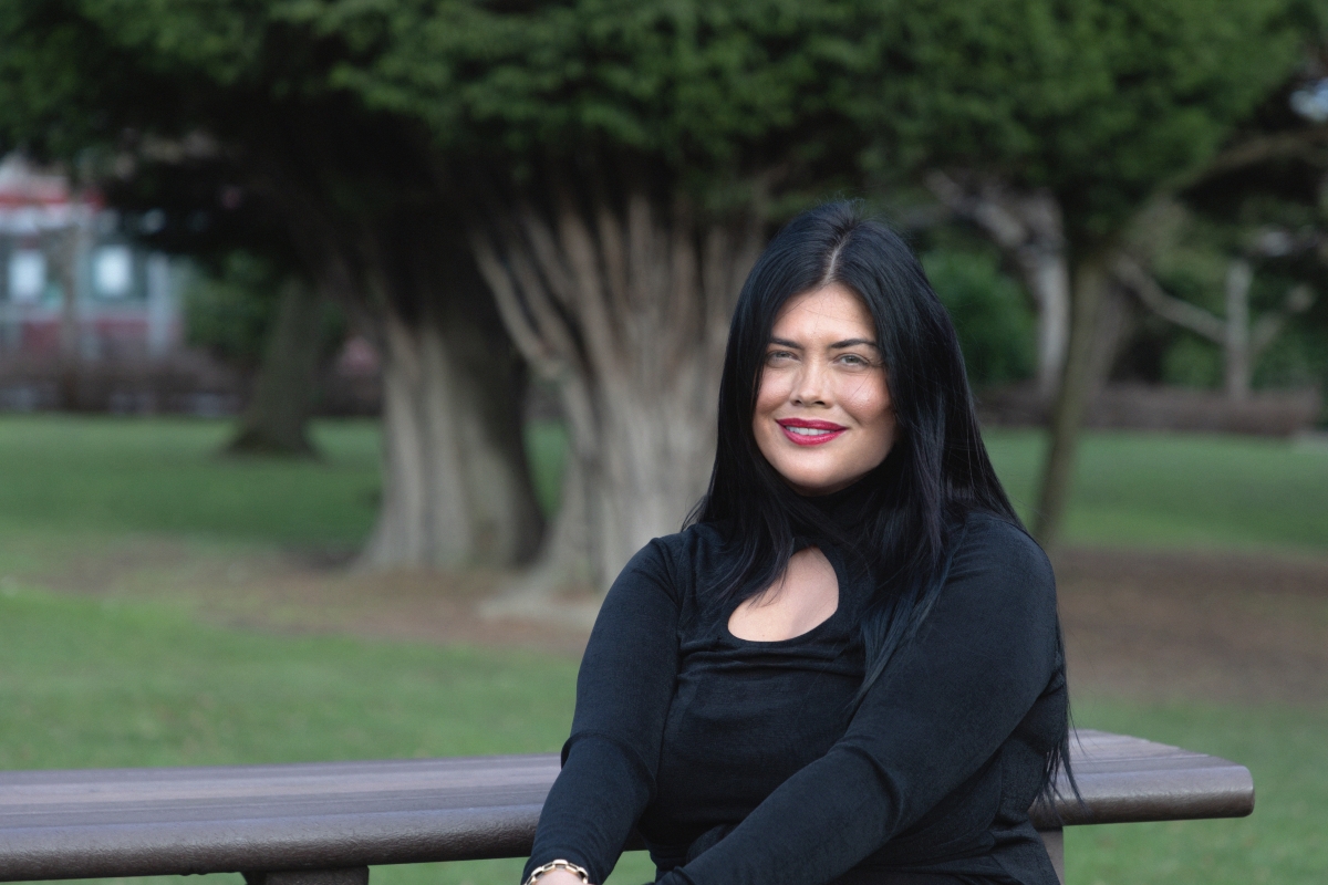 Criminology student sits outside Main Campus.